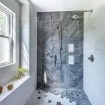 Gorgeous interior renovation bathroom remodeling job by General Contractor Drill Renovations. Trendy stone and mable tile with bright window in Scottsdale luxury home.
