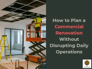 Construction crew working inside a Scottsdale office during a commercial renovation with protective barriers, ladders, and ceiling work in progress.